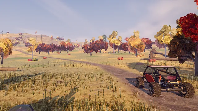 A buggy on a dirt trail through autumn trees and tall grass.